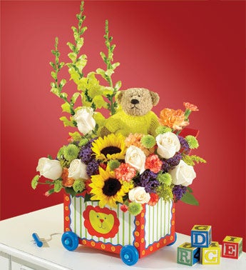 sunflower and rose arrangement with plush on wagon